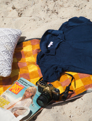 Hapeto Navy Terry Towel Resort Polo Shirt On A Yellow Towel