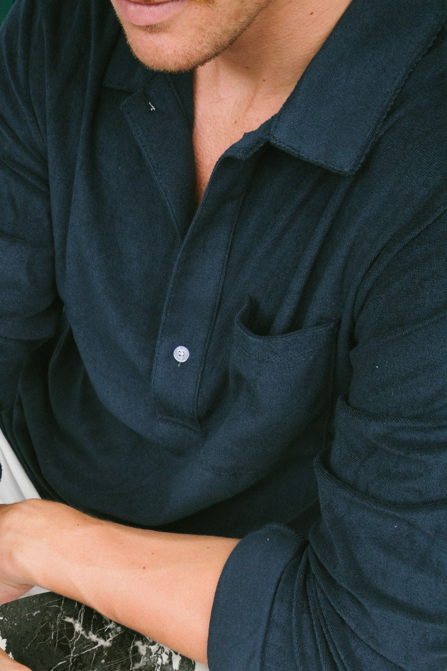 Close up photo of the buttons  navy Signature Terry Towelling Long Sleeve Polo by Hapeto.